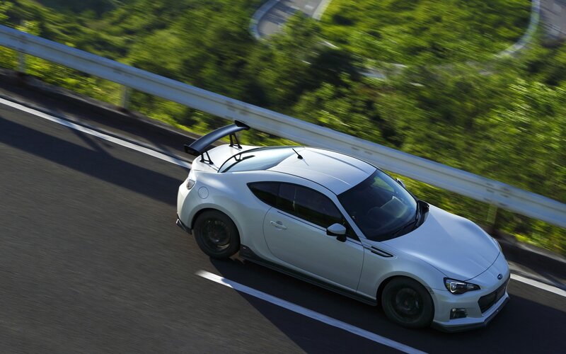white sports car on winding road