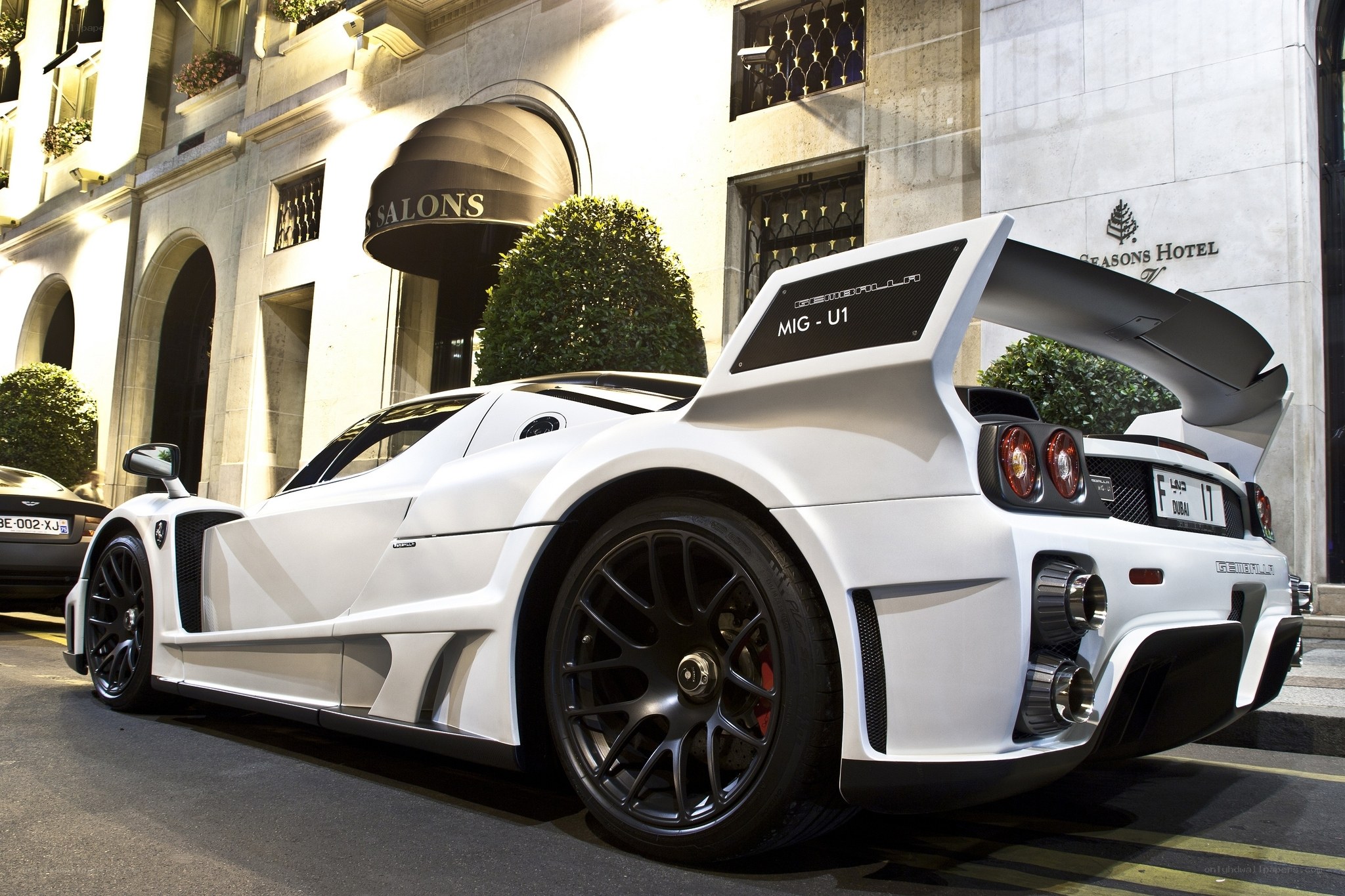 White sports car outside hotel