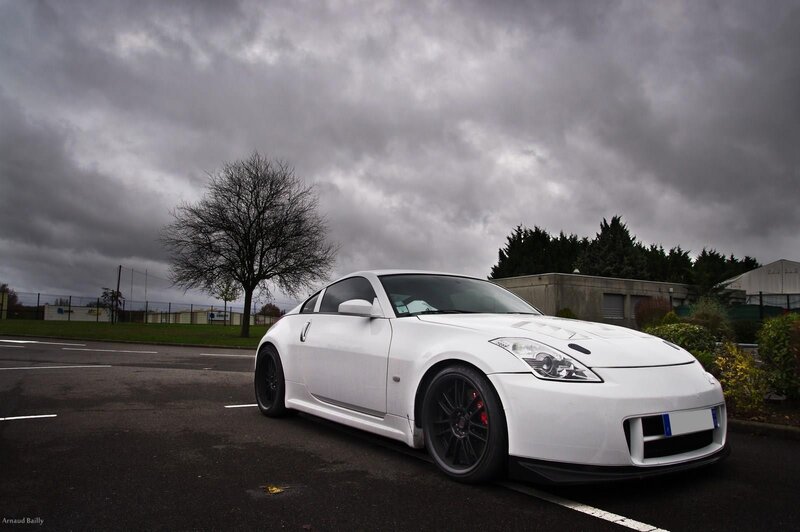 white sports car under cloudy sky