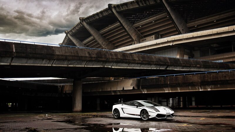 White sports car under concrete bridge