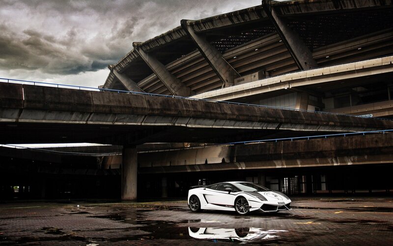 White sports car under concrete structure