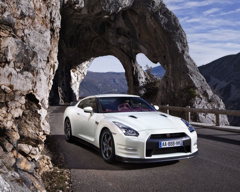 White sports car under rock arch