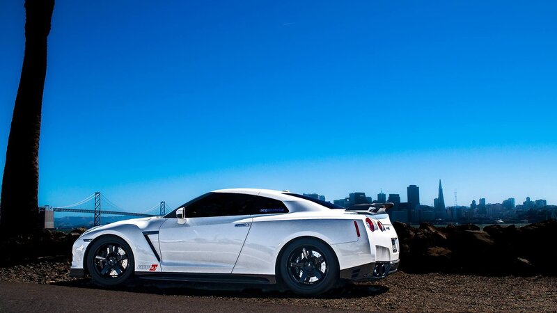 White sports car with city skyline