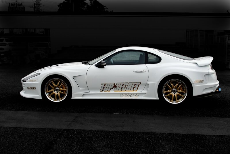 white sports car with gold wheels