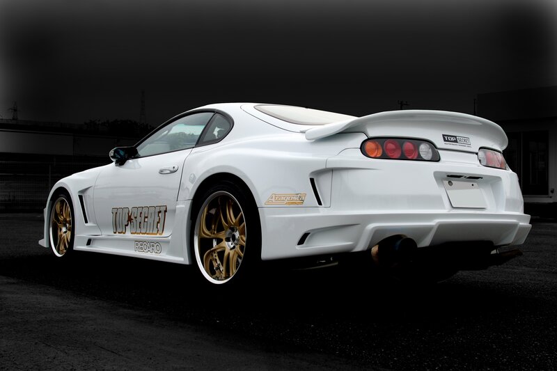 white sports car with gold wheels