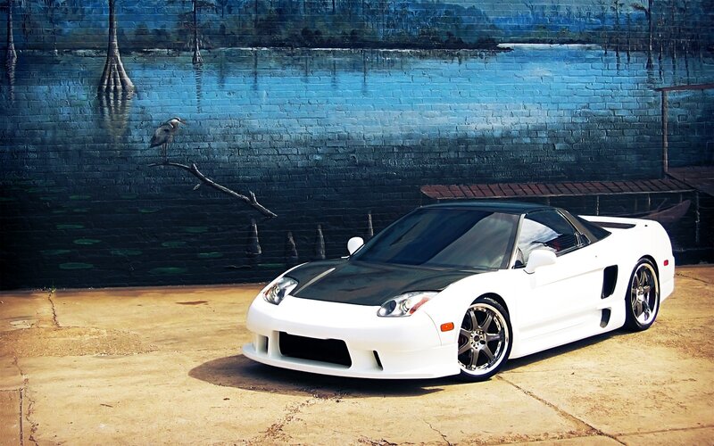 White sports car with mural background
