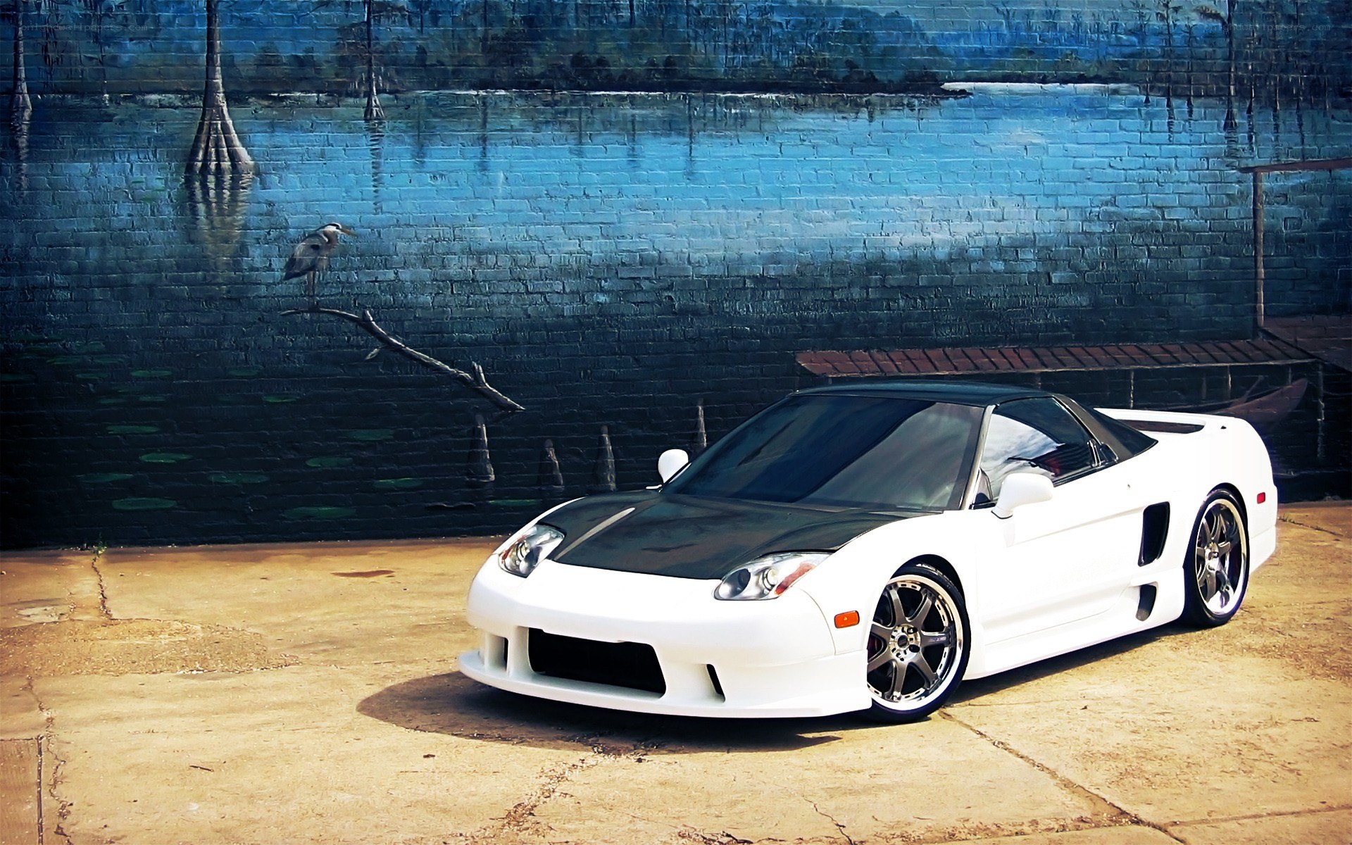 White sports car with mural background