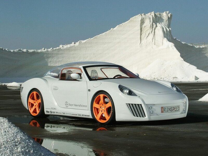 White sports car with orange wheels