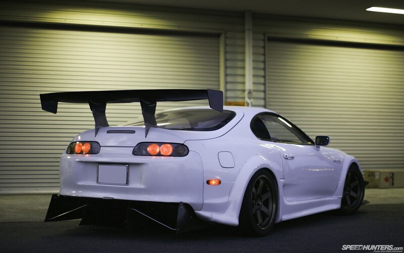 white sports car with rear wing