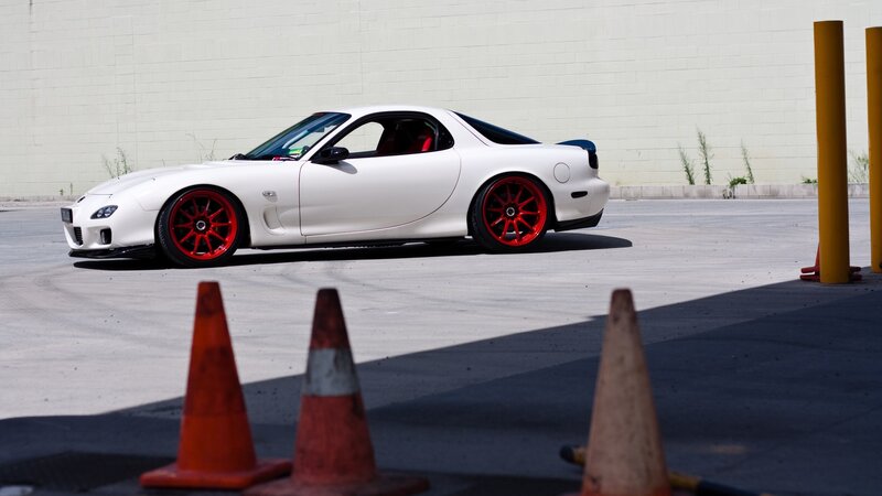 white sports car with red wheels