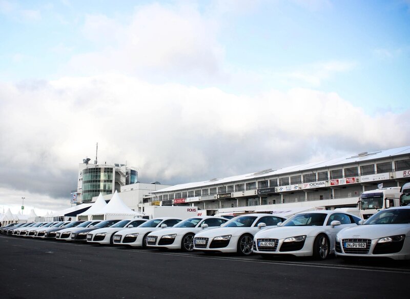 White sports cars at a race track