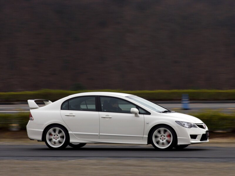 white sports sedan in motion