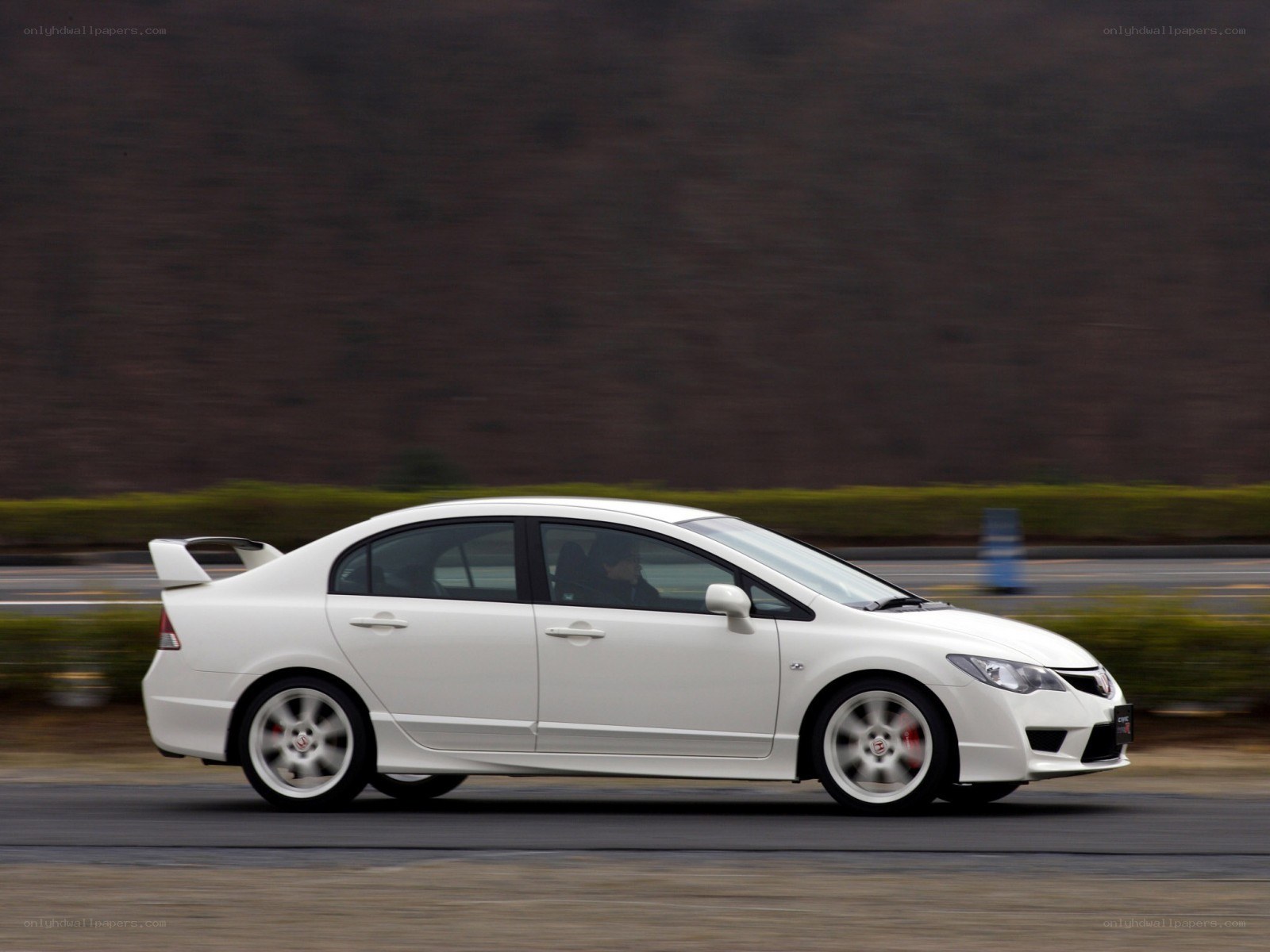 white sports sedan in motion