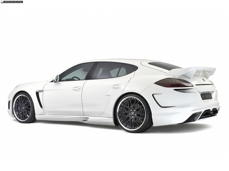 white sports sedan with rear wing