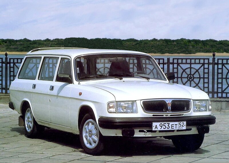 white station wagon by water