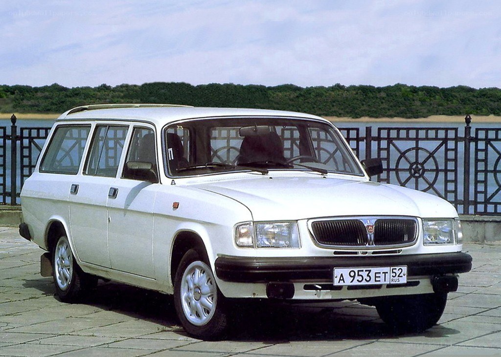 white station wagon by water