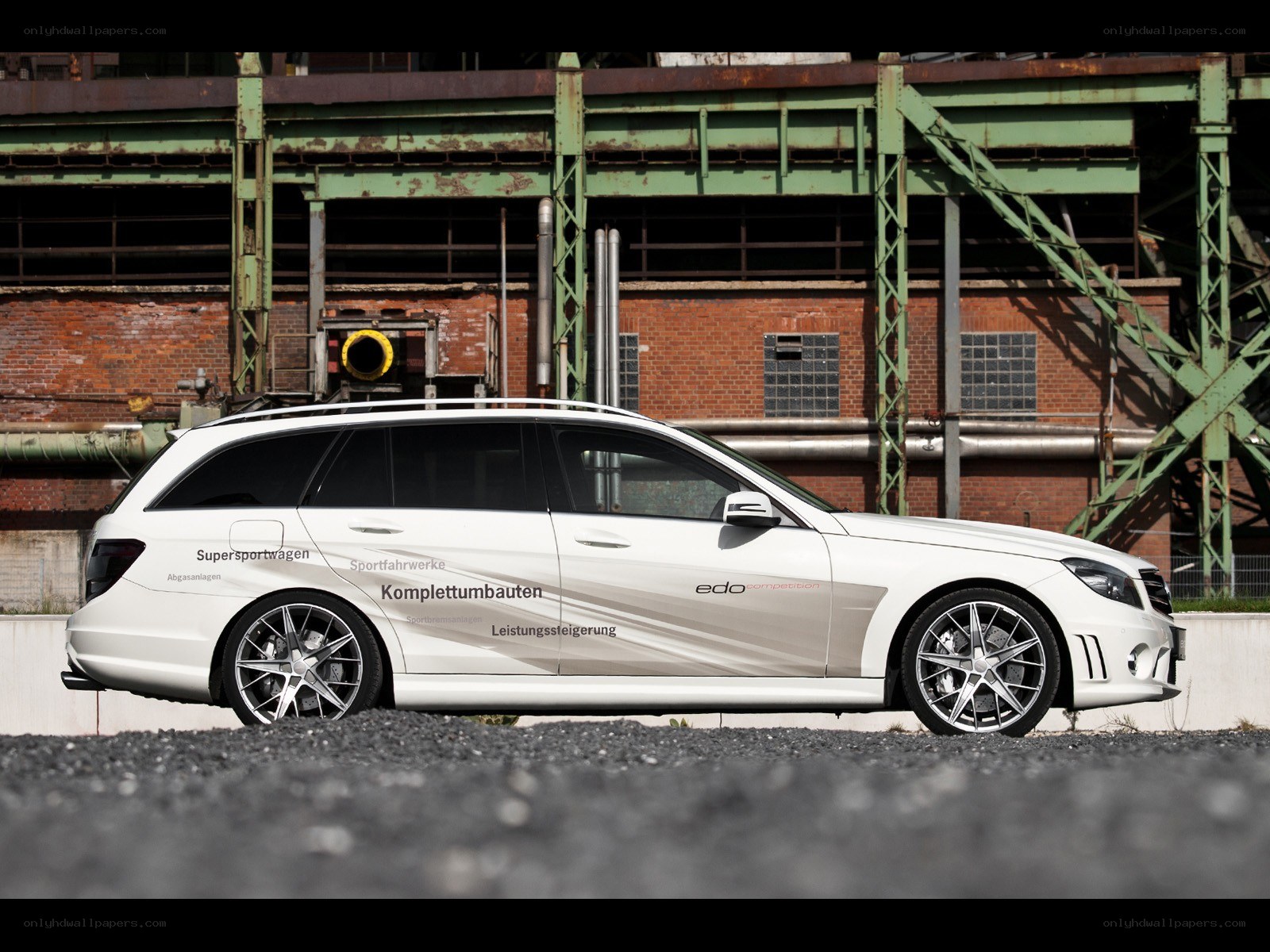 white station wagon in industrial setting