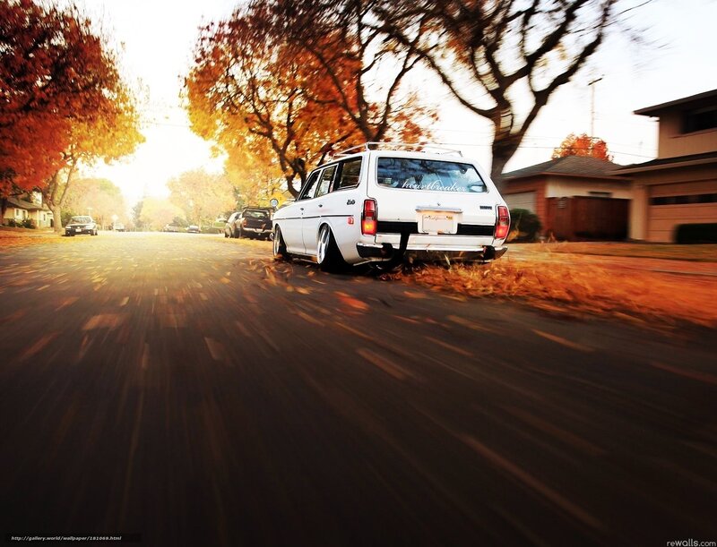 White station wagon on autumn street