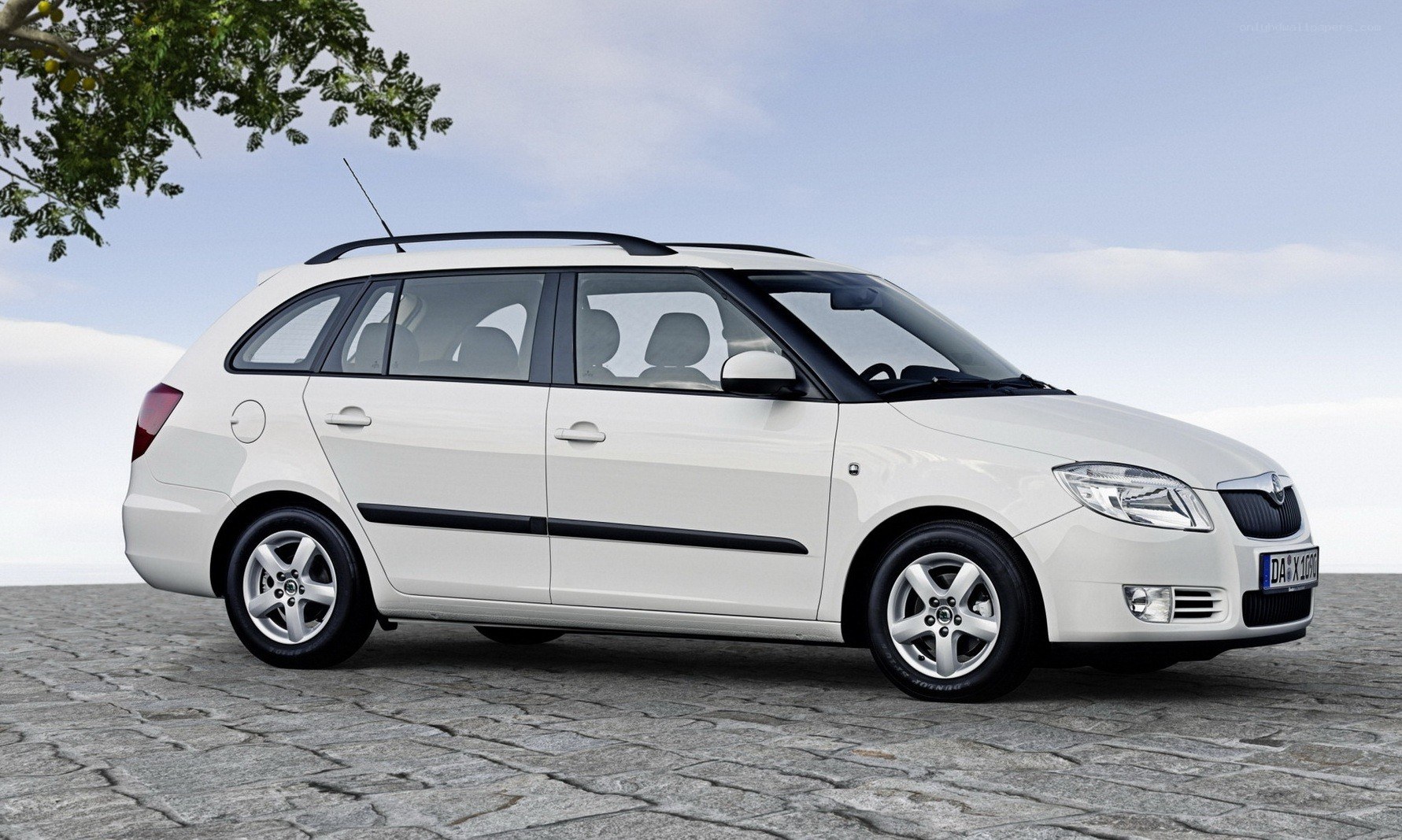 white station wagon on cobblestones