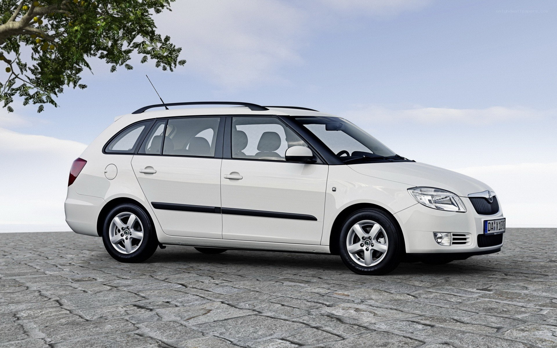 white station wagon on cobblestones