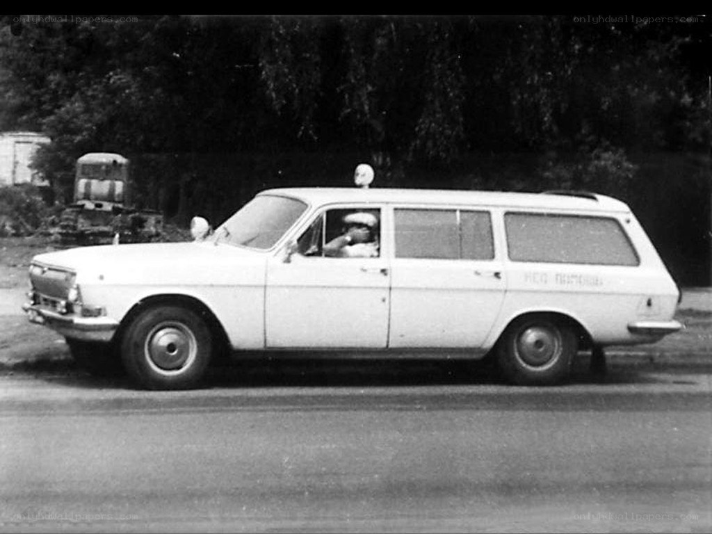 White station wagon with driver
