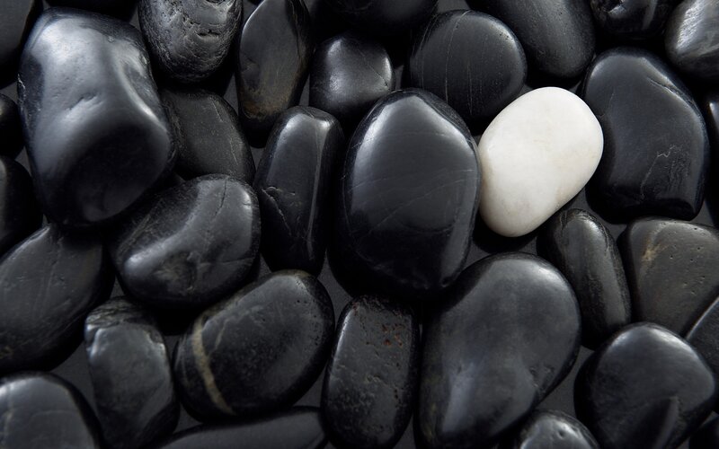 White Stone Among Black Pebbles