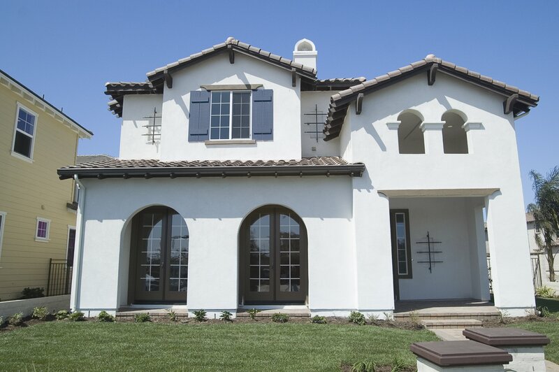 white stucco house with arched windows