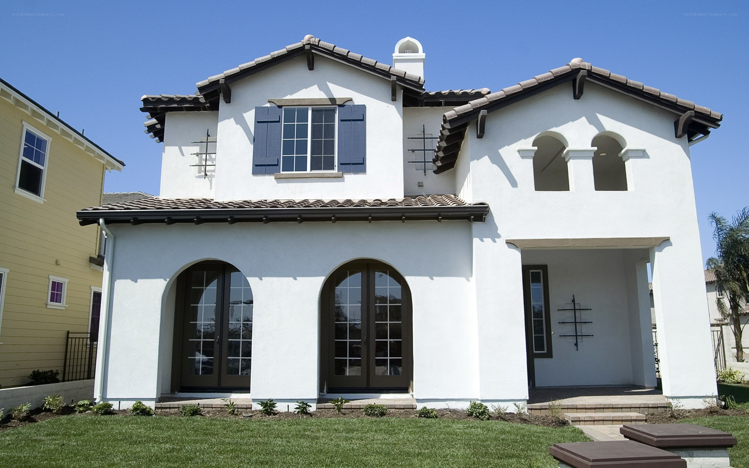 white stucco house with arched windows
