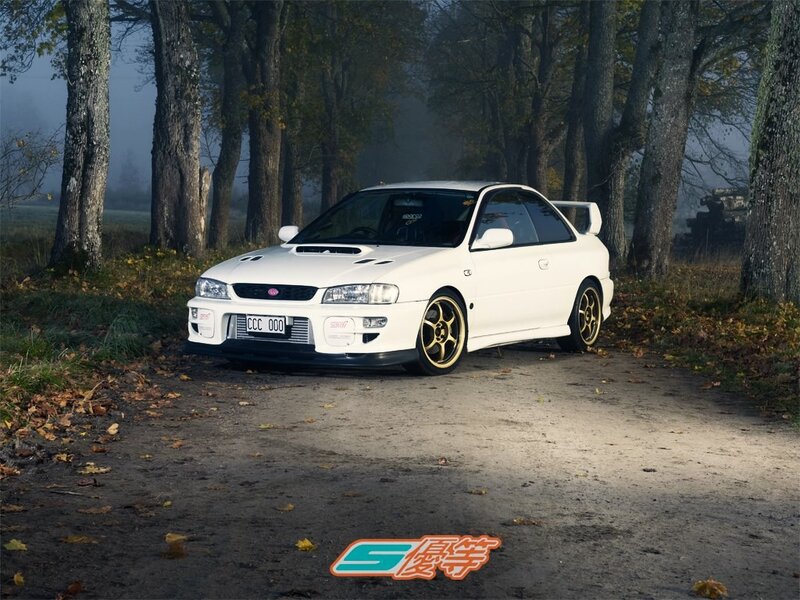 White Subaru in a forest