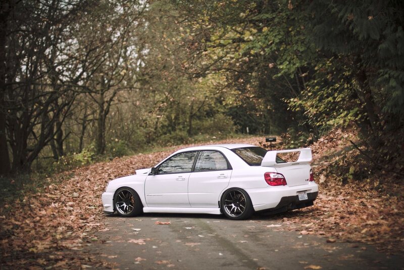 White Subaru in autumn forest