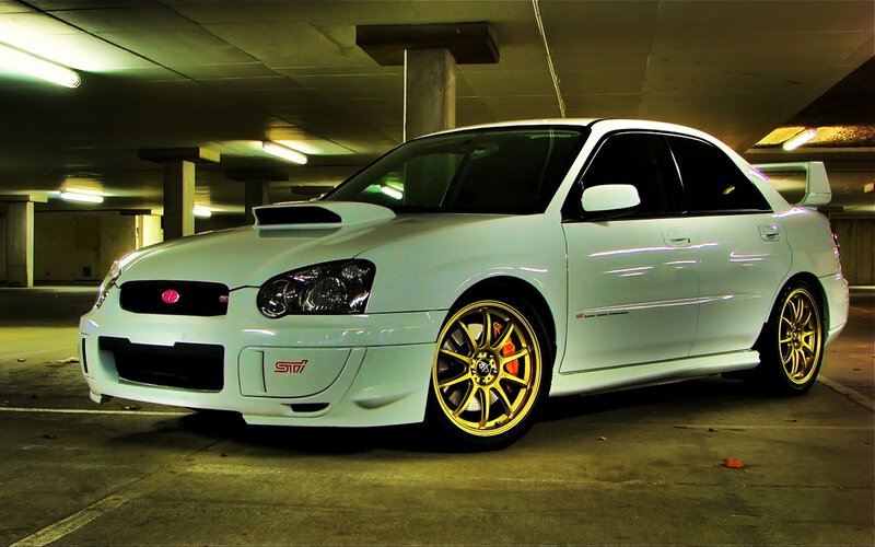 white subaru in parking garage