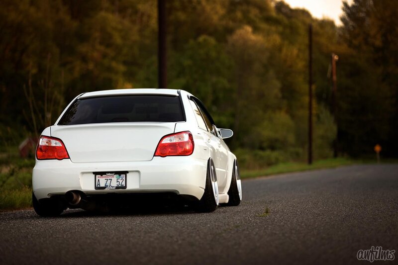 white subaru on a country road
