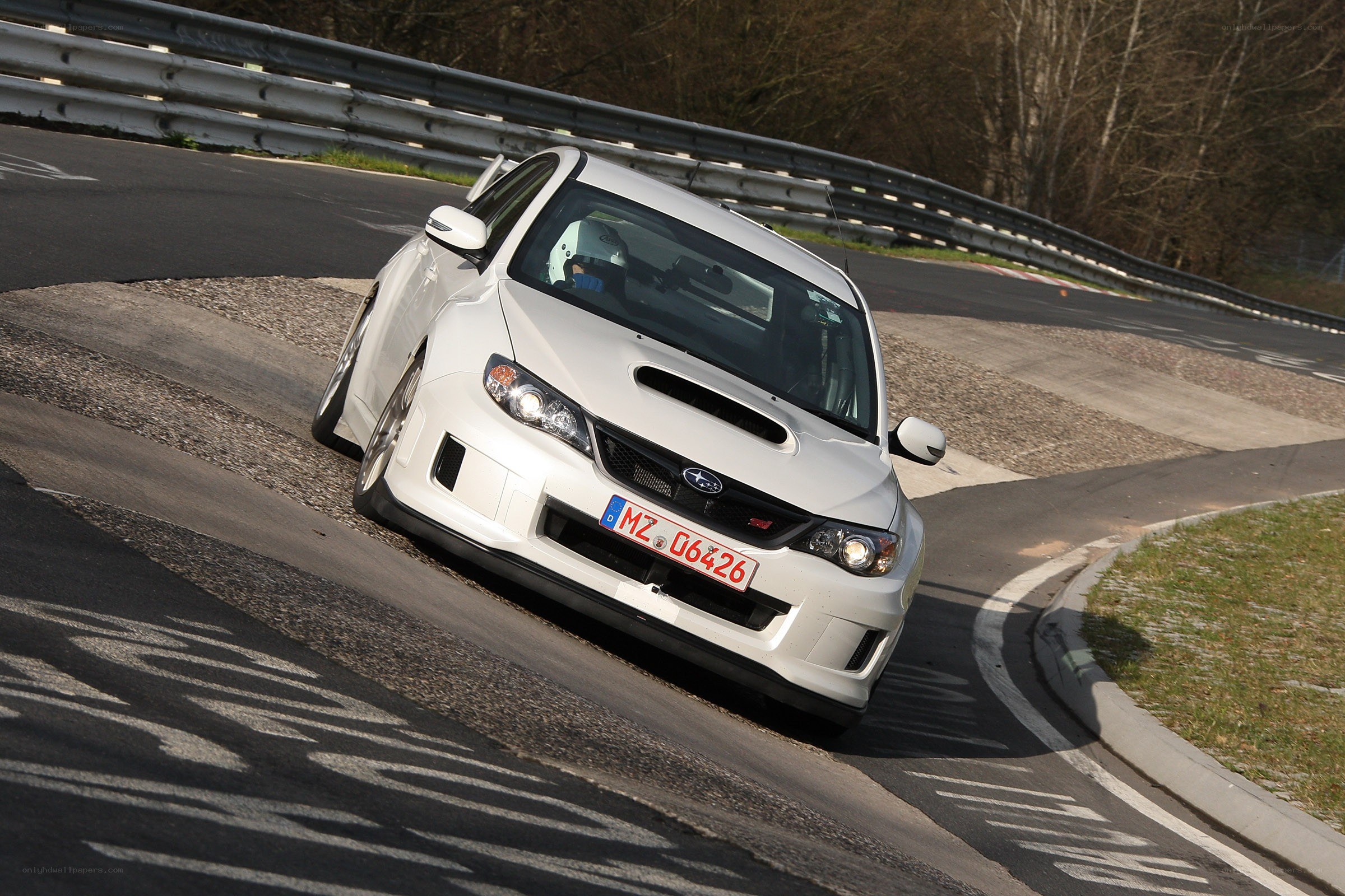 White Subaru on a racetrack