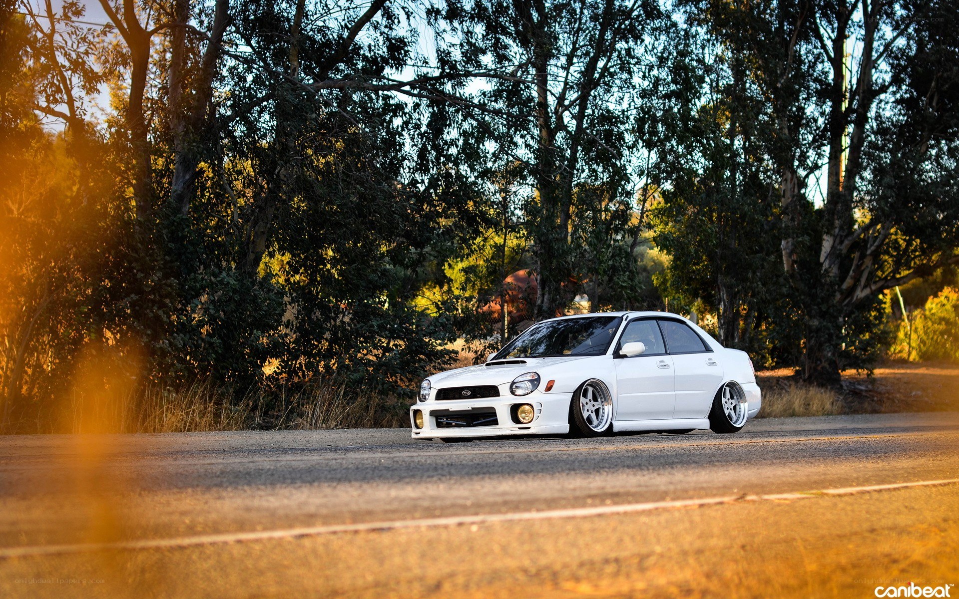 white subaru on a road
