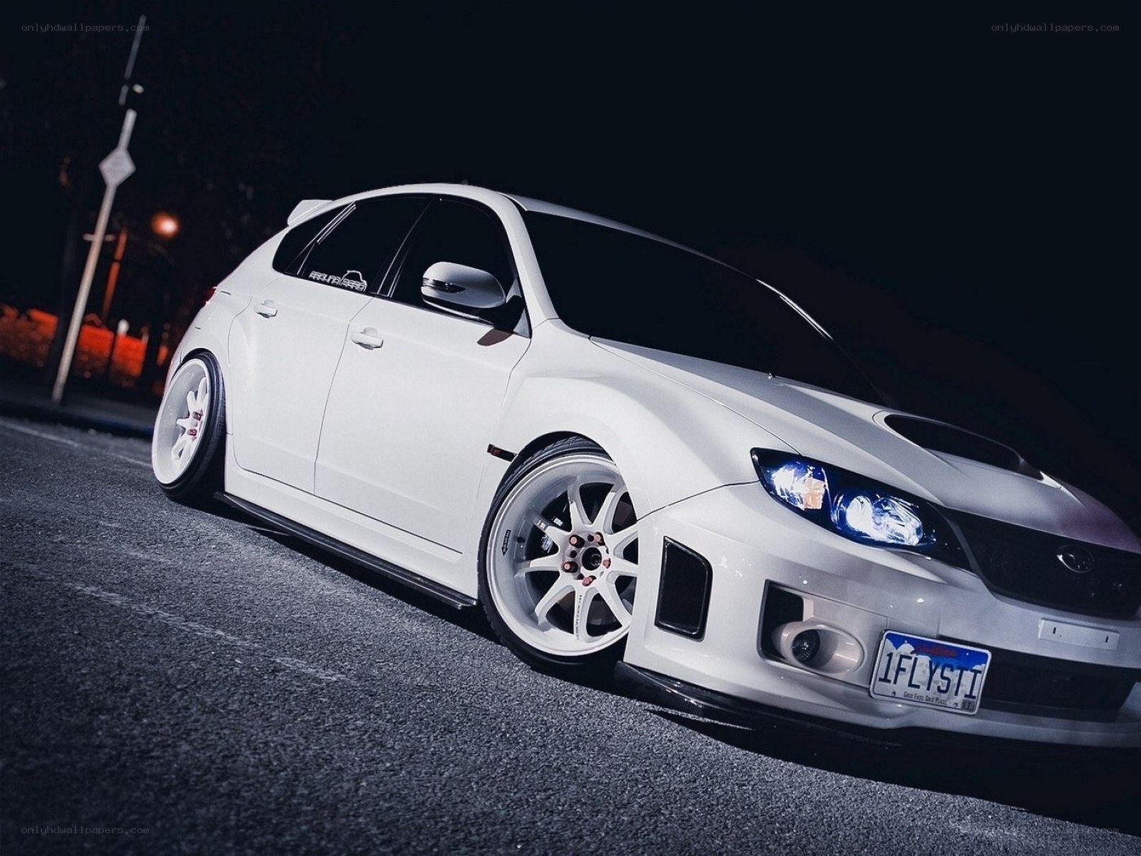white subaru on dark street