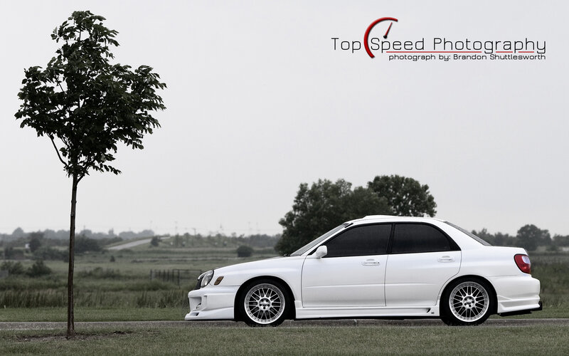 white subaru on grass