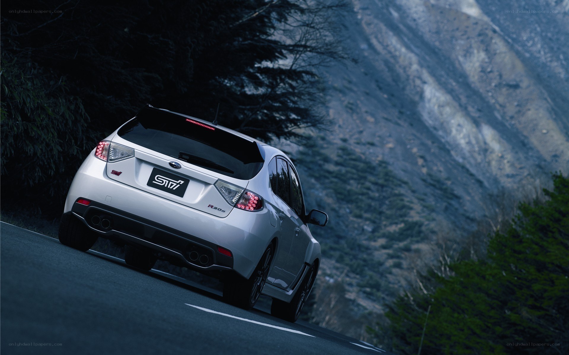 White Subaru on mountain road
