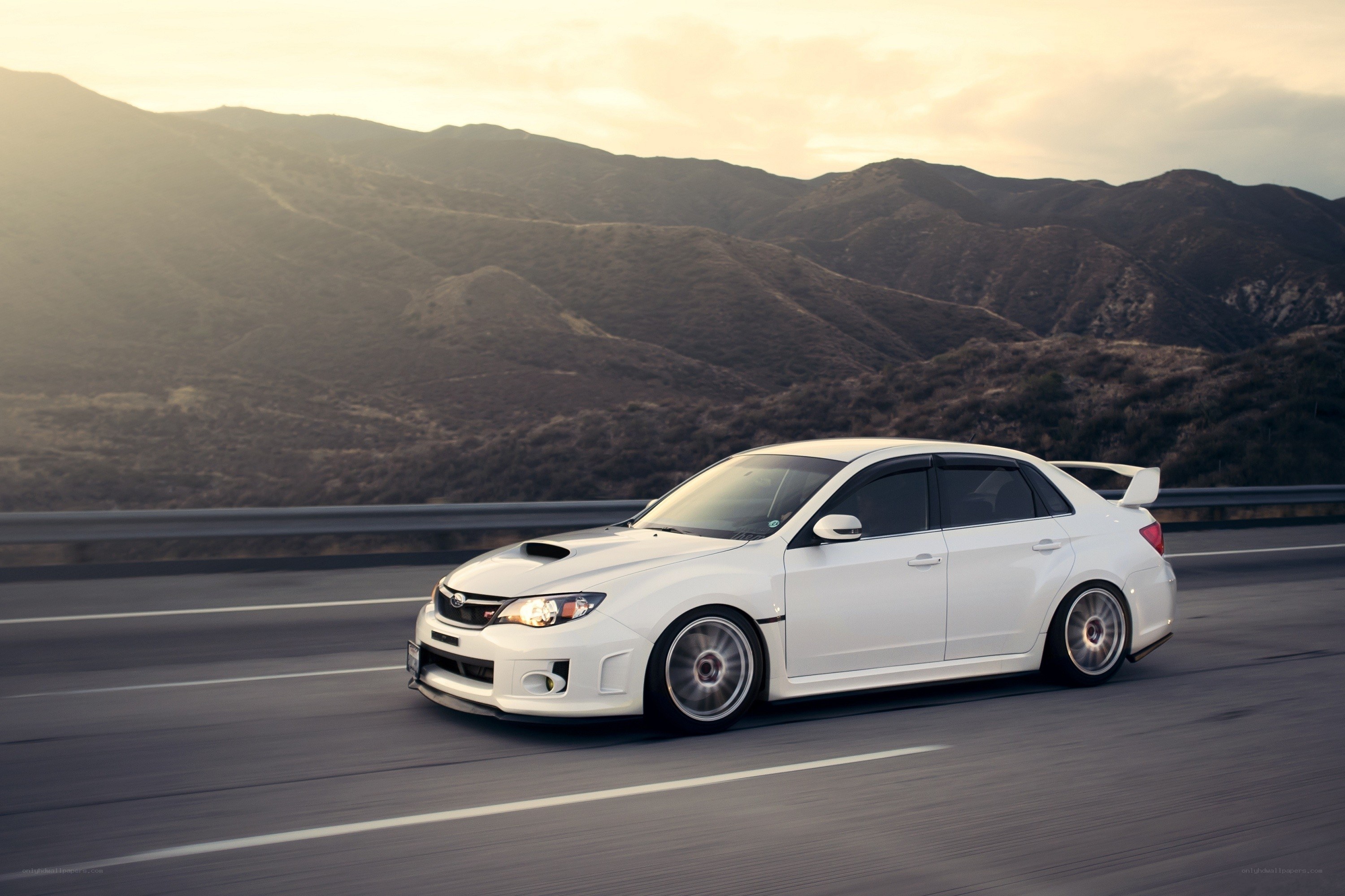 White Subaru on mountain road
