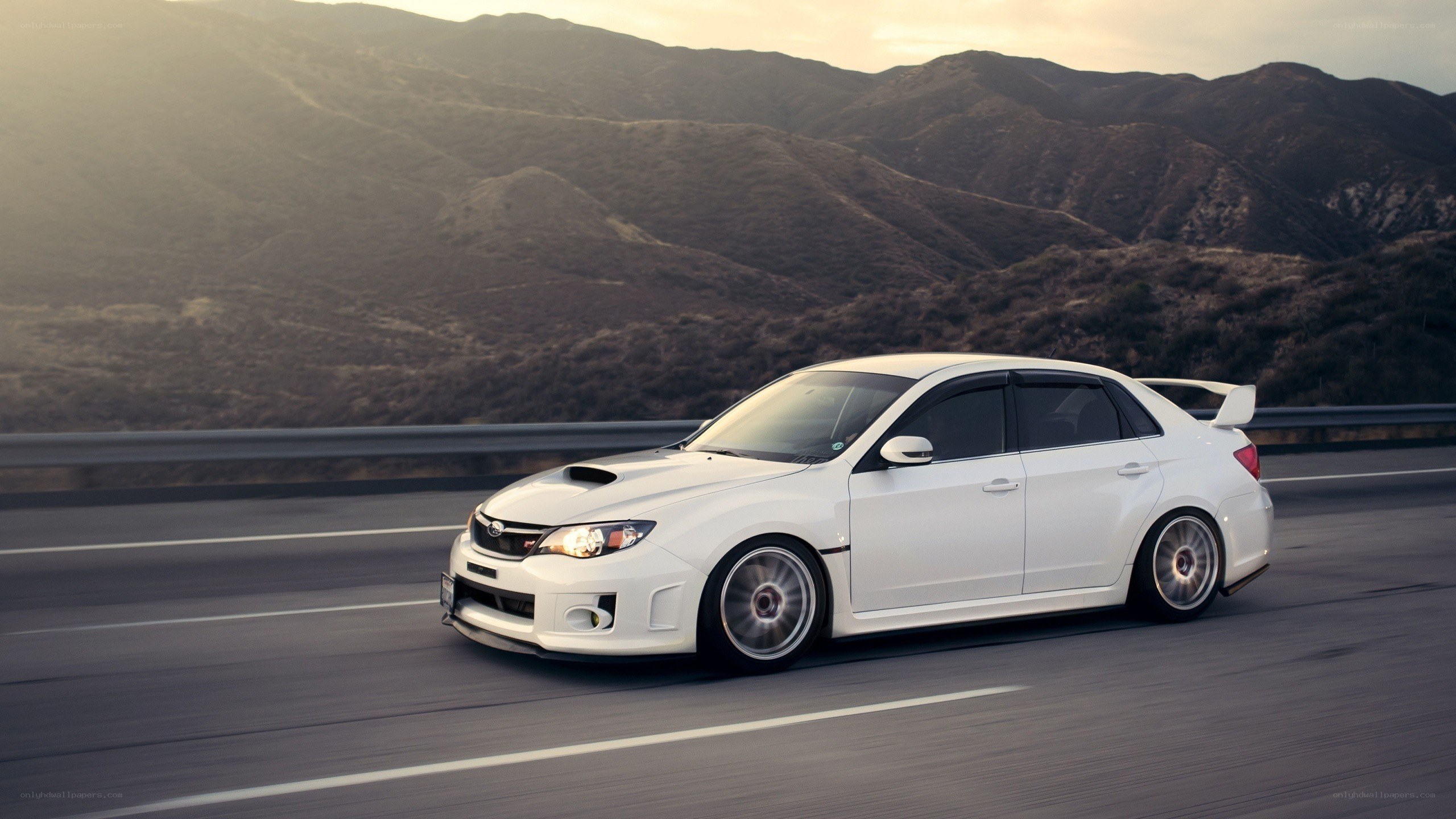 white subaru on mountain road