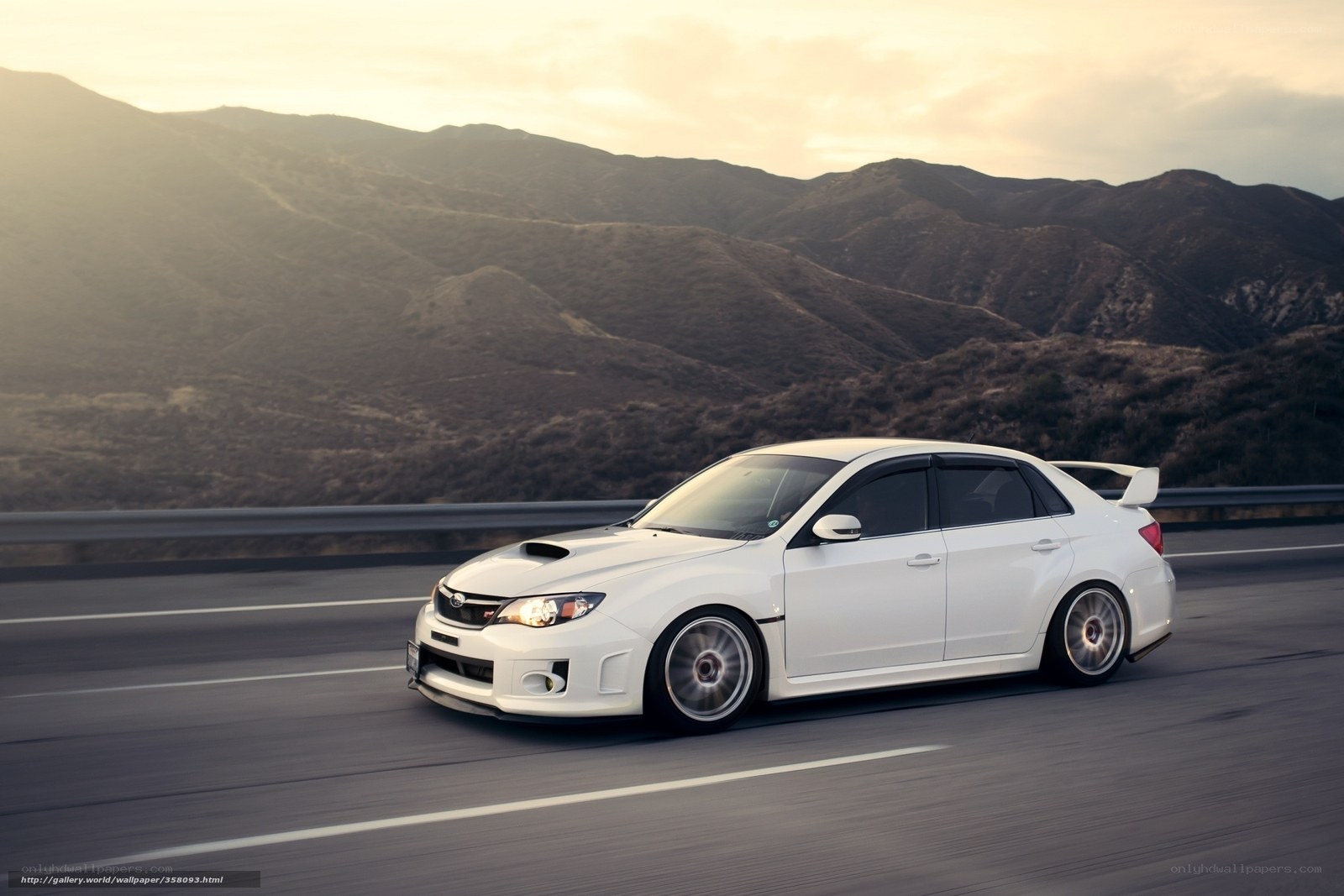 white subaru on mountain road