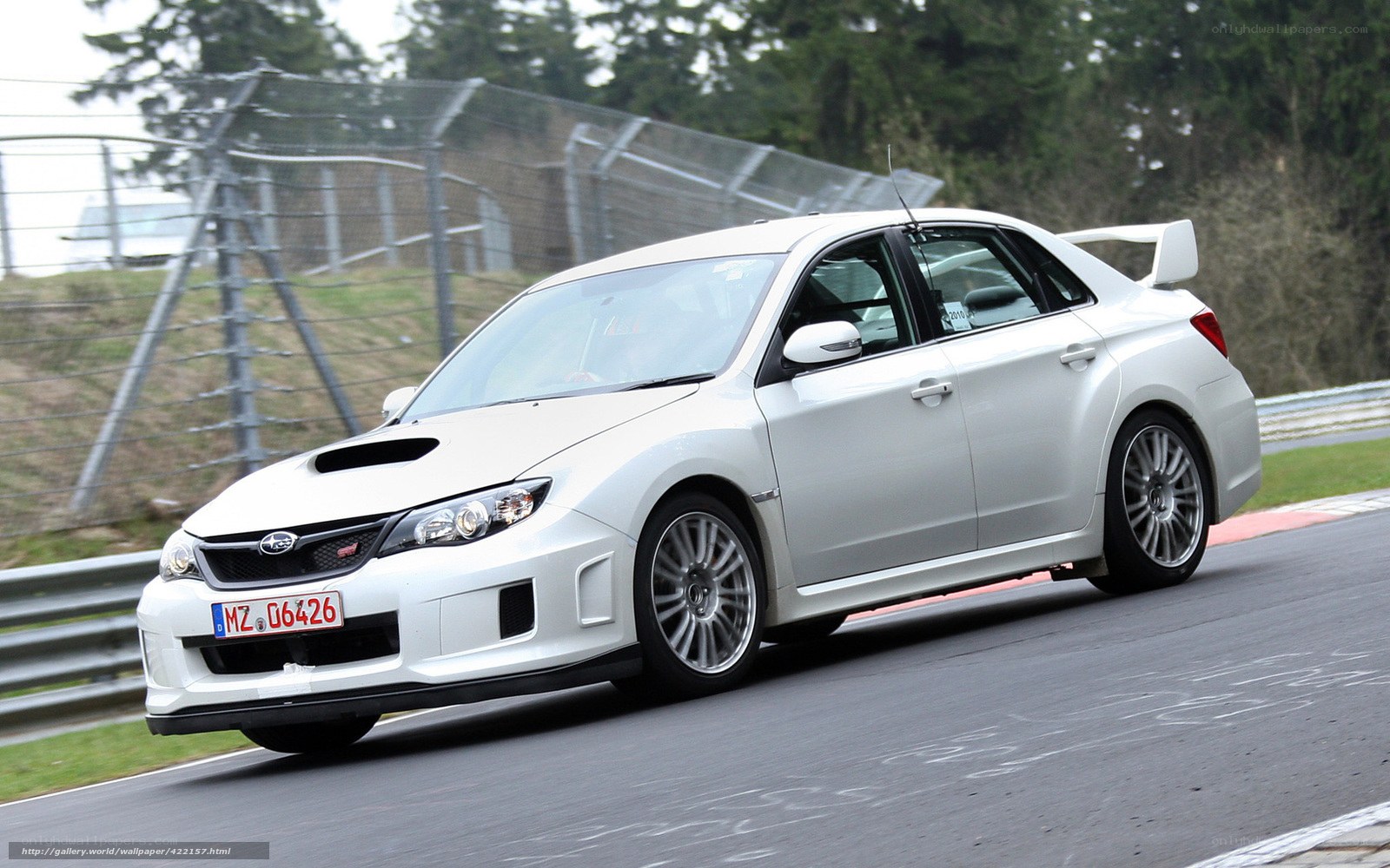 white subaru on racetrack