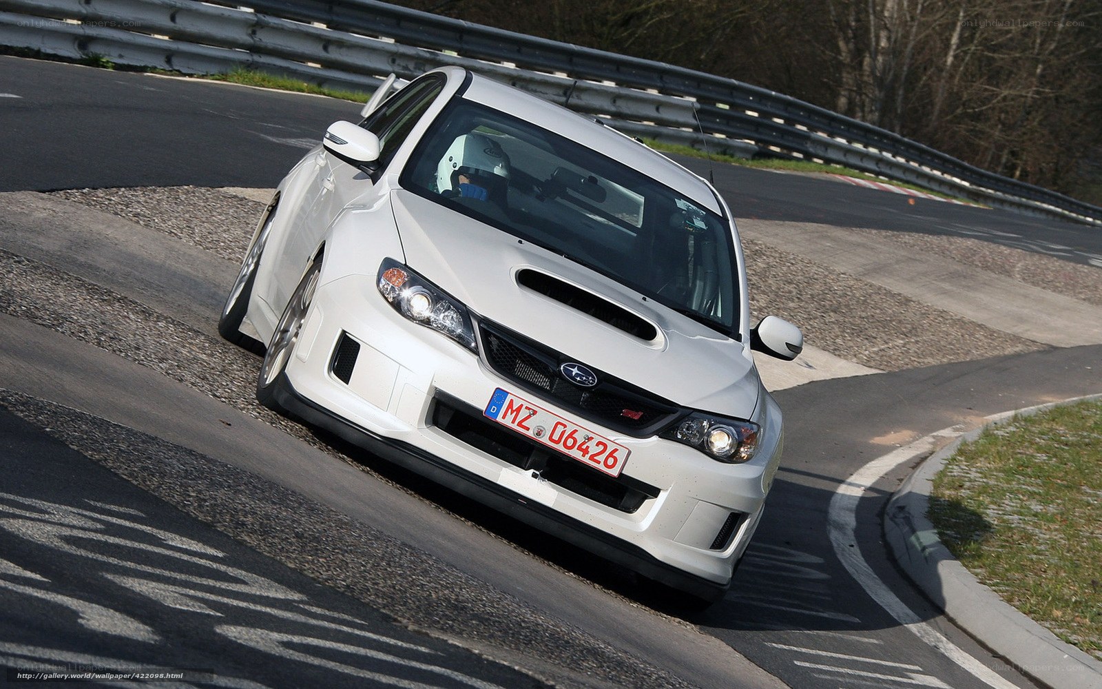 white subaru on racetrack