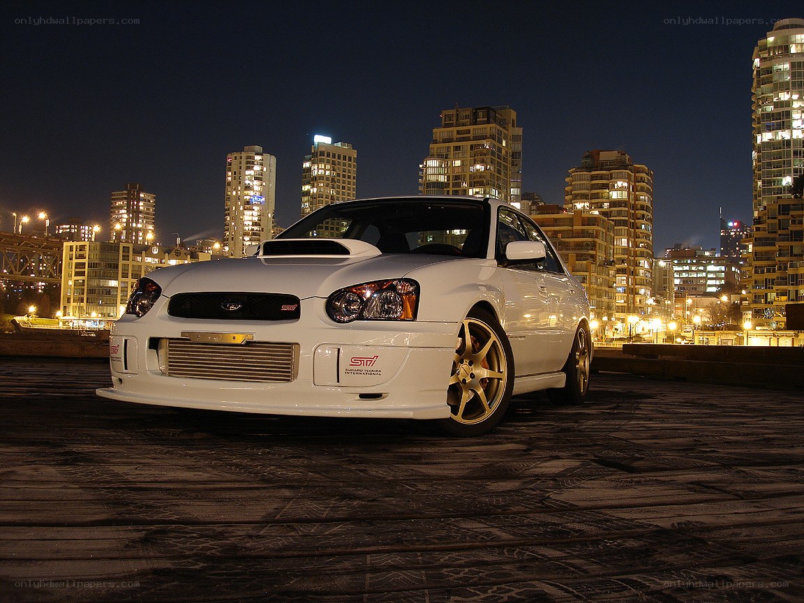white subaru on rooftop at night