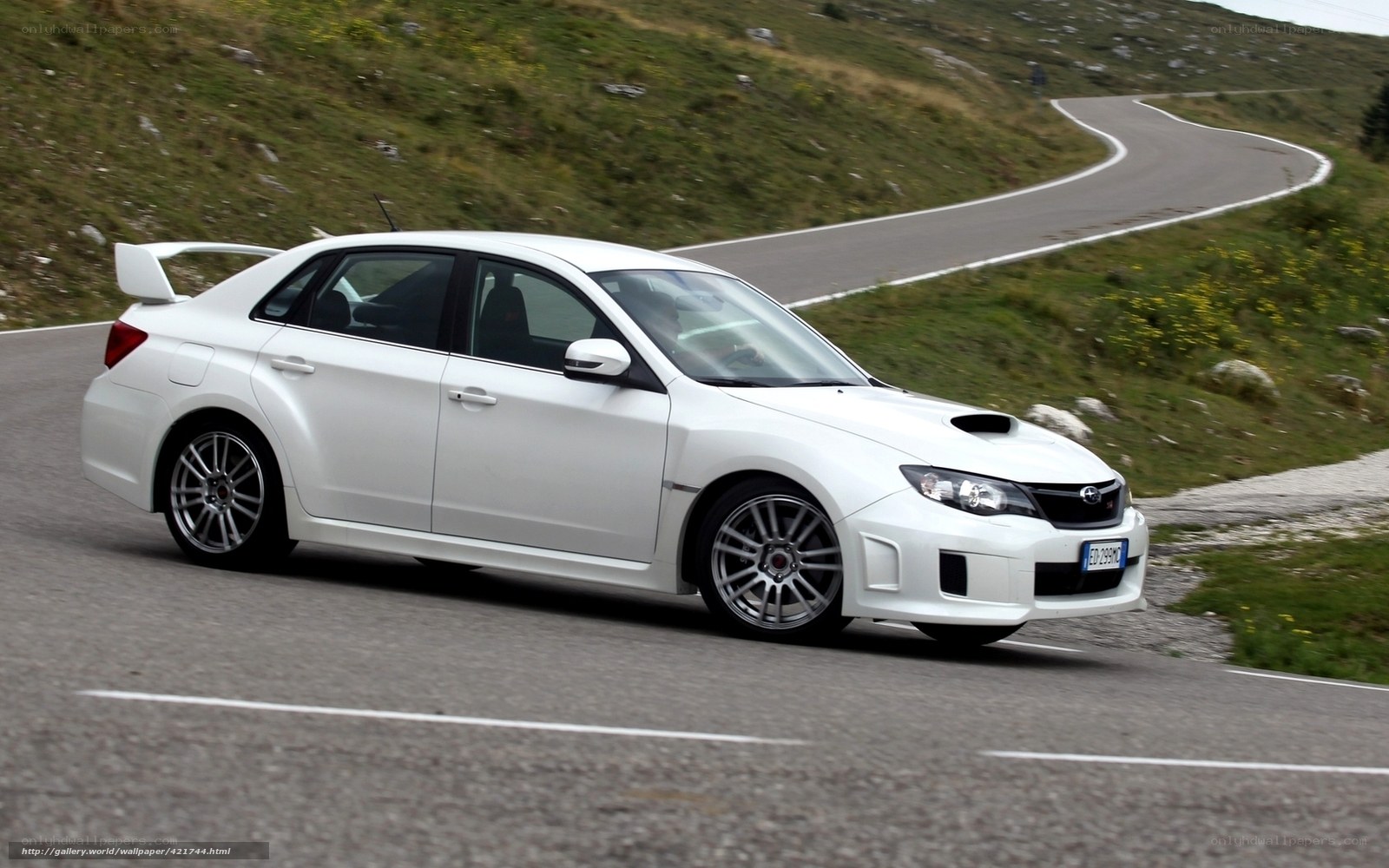 white subaru on winding road