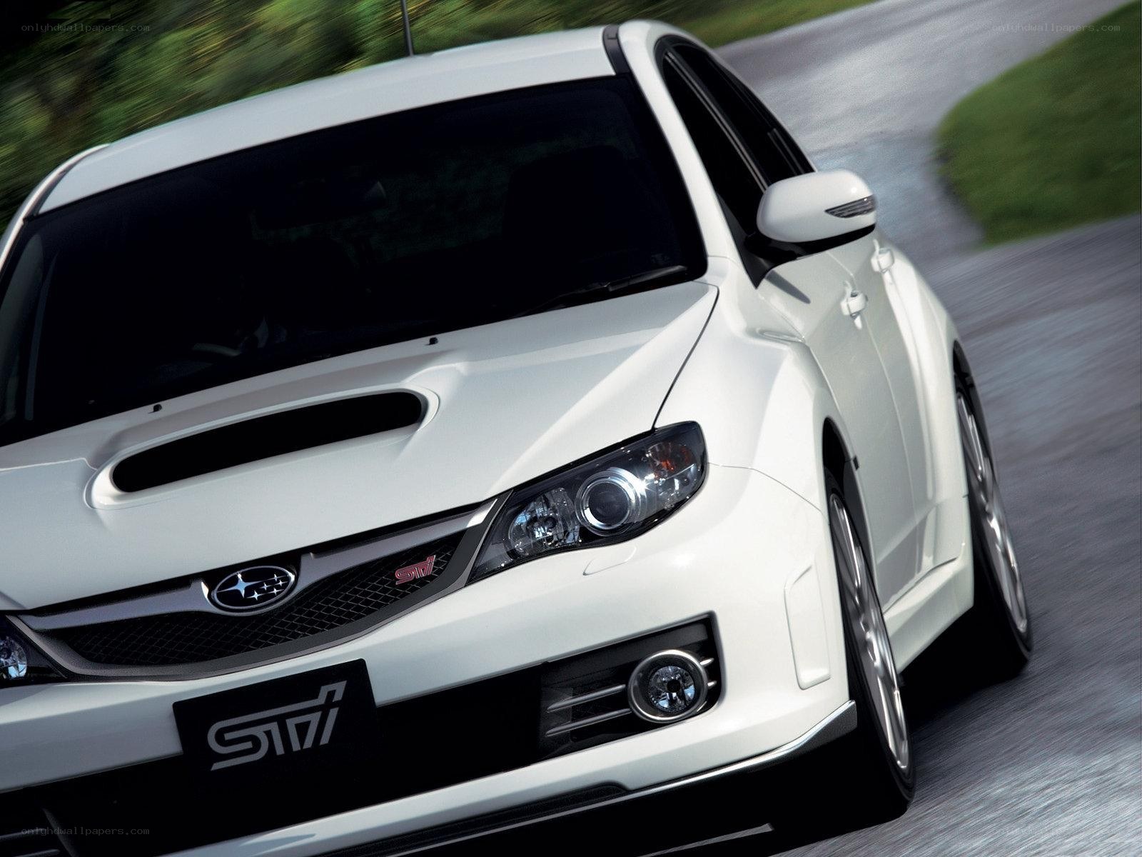 white subaru sti in motion