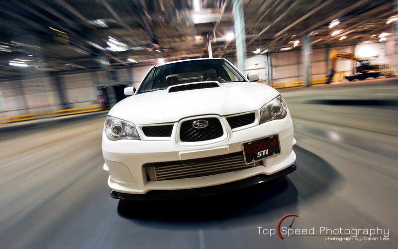 White Subaru STI in motion