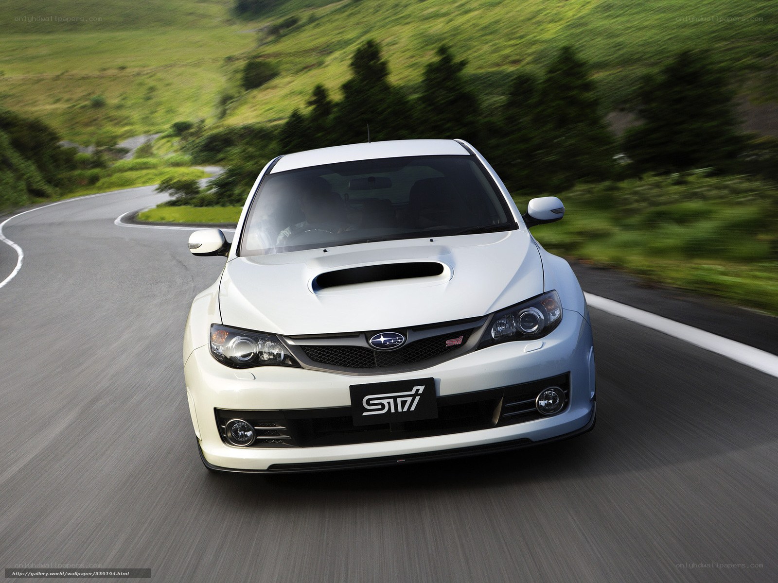 white subaru sti on winding road
