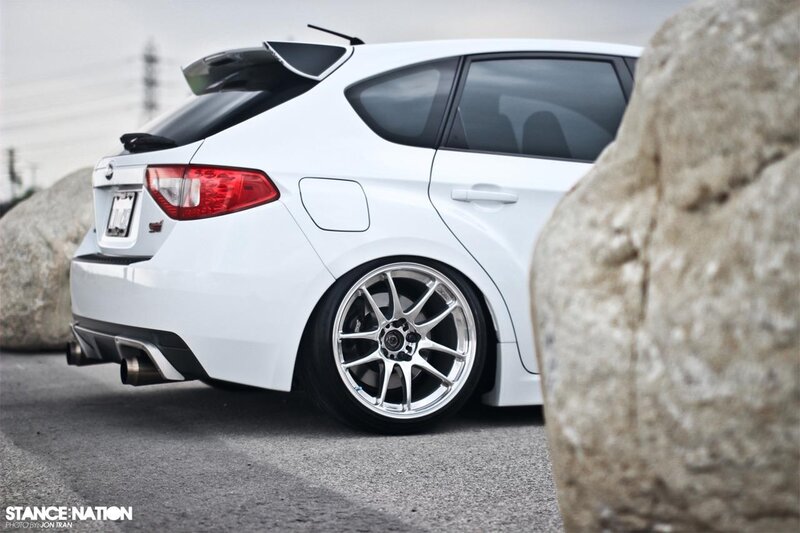 white subaru with custom wheels