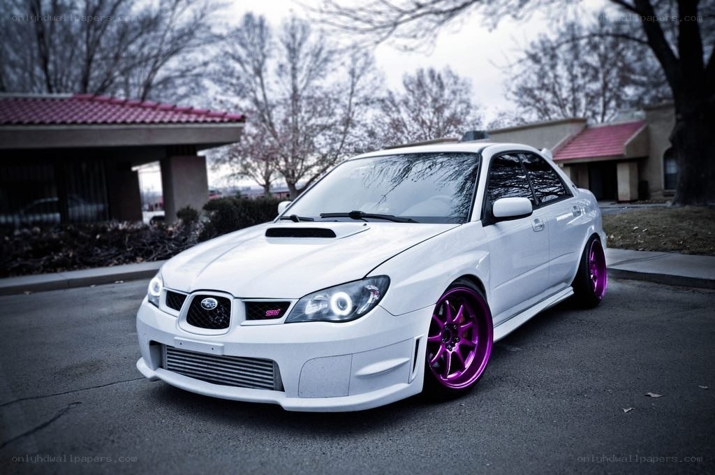 white subaru with purple wheels