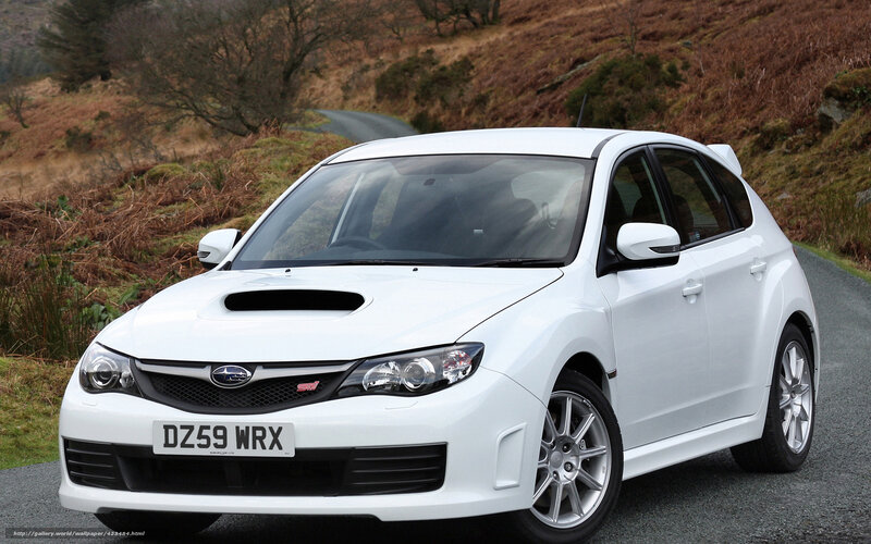 white subaru wrx on a country road